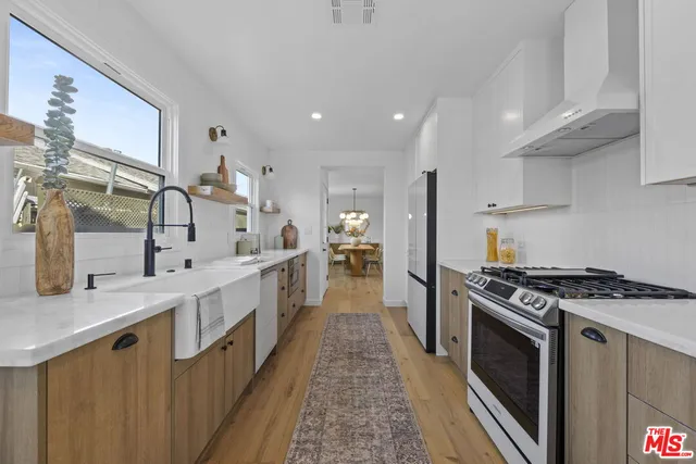 a kitchen with stainless steel appliances granite countertop a stove and a sink