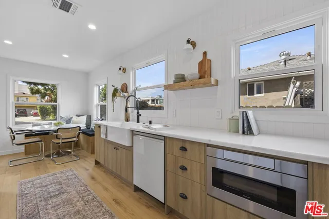 a kitchen that has a sink and a stove in it
