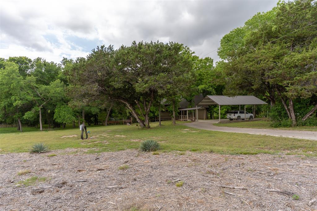 377 County Road 2530 Meridian, TX 76665 - Photo 21 of 25 a view of a house with a yard and large trees
