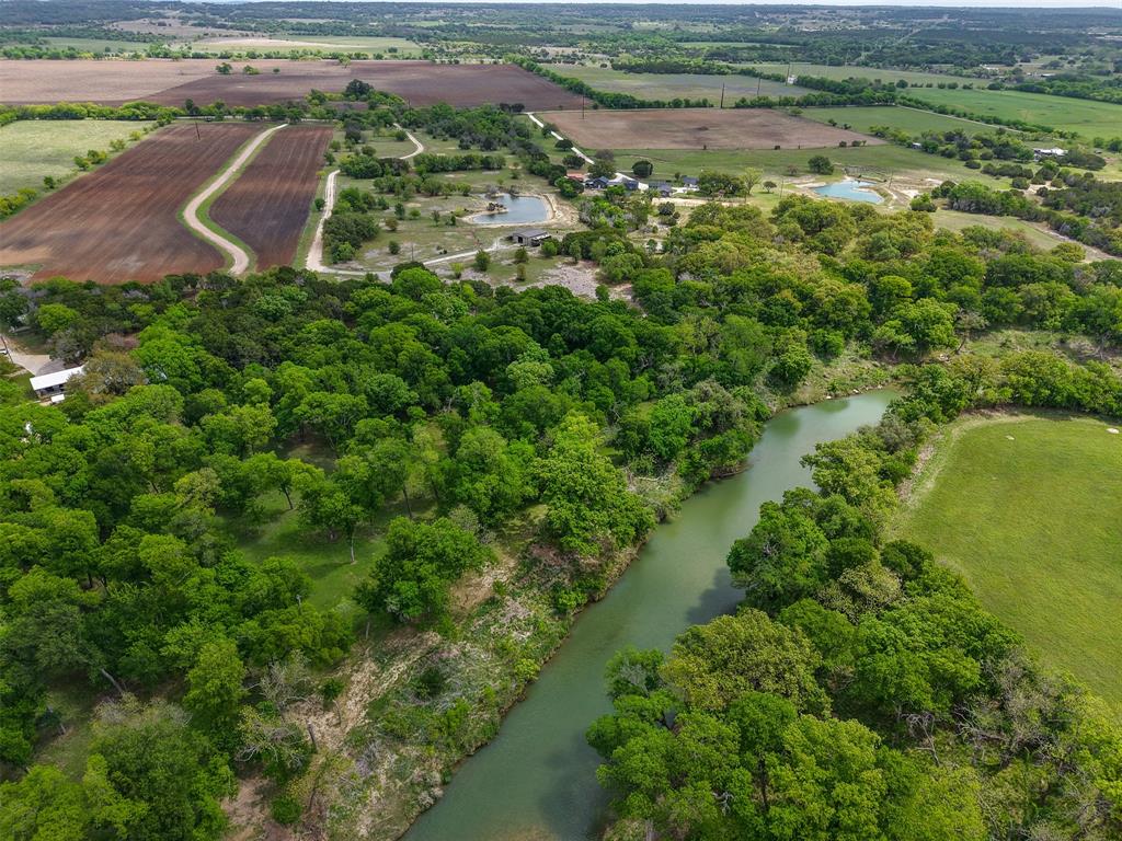 377 County Road 2530 Meridian, TX 76665 - Photo 3 of 25 an aerial view of residential houses with outdoor space and trees