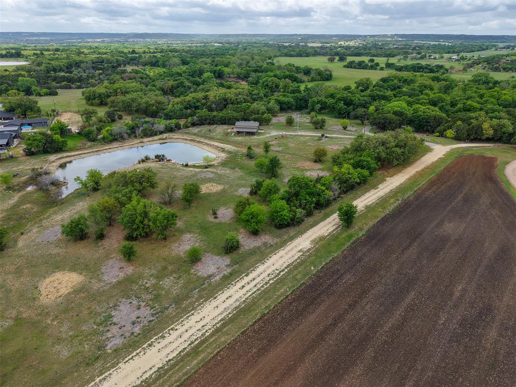 377 County Road 2530 Meridian, TX 76665 - Photo 5 of 25 a view of a lush green forest with a lake
