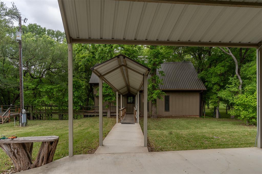 377 County Road 2530 Meridian, TX 76665 - Photo 8 of 25 a front view of a house with garden