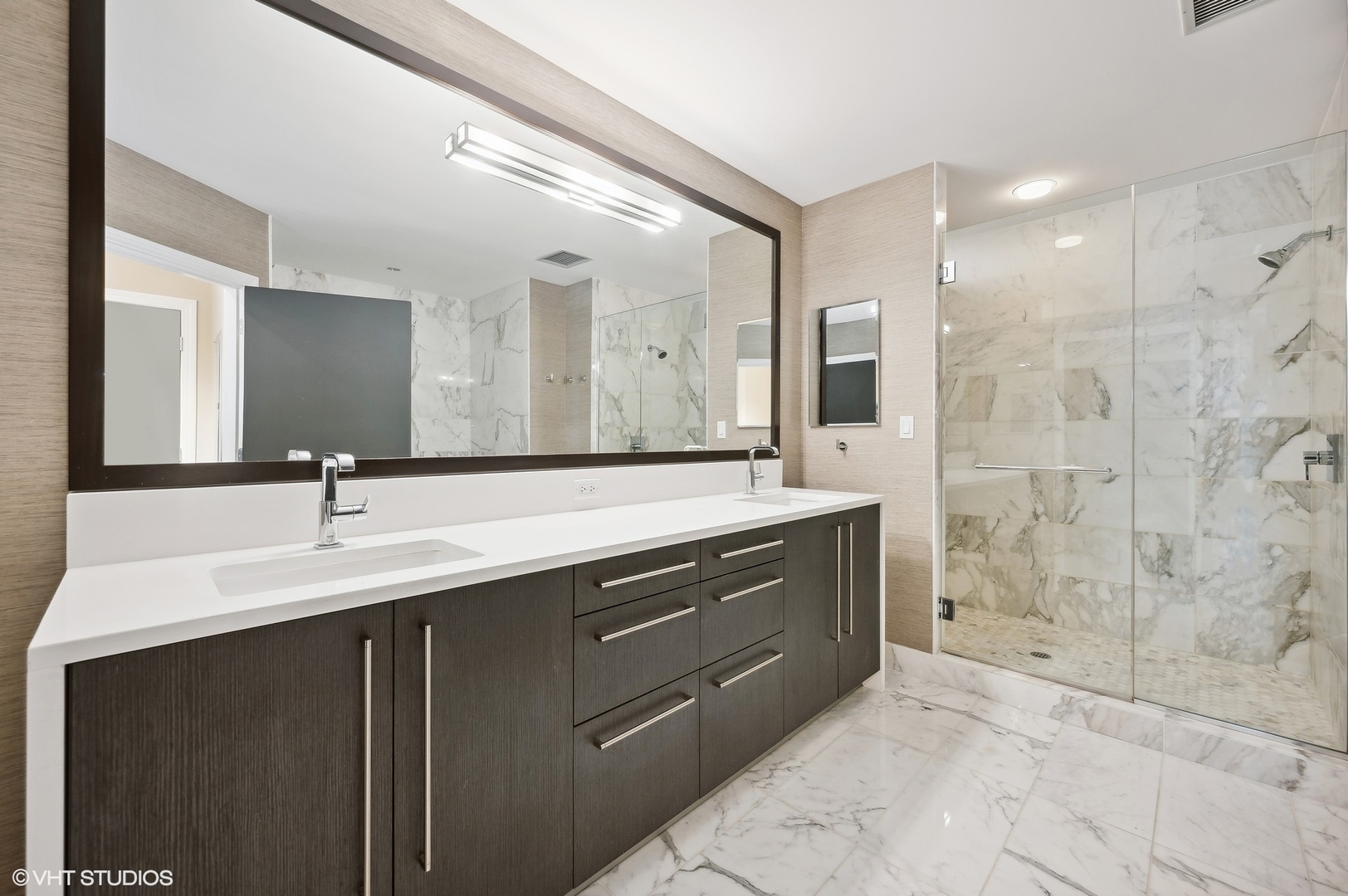 1201 South Prairie Avenue, Unit 4501 Chicago, IL 60605 - Photo 18 of 52 a bathroom with a double vanity sink mirror and shower