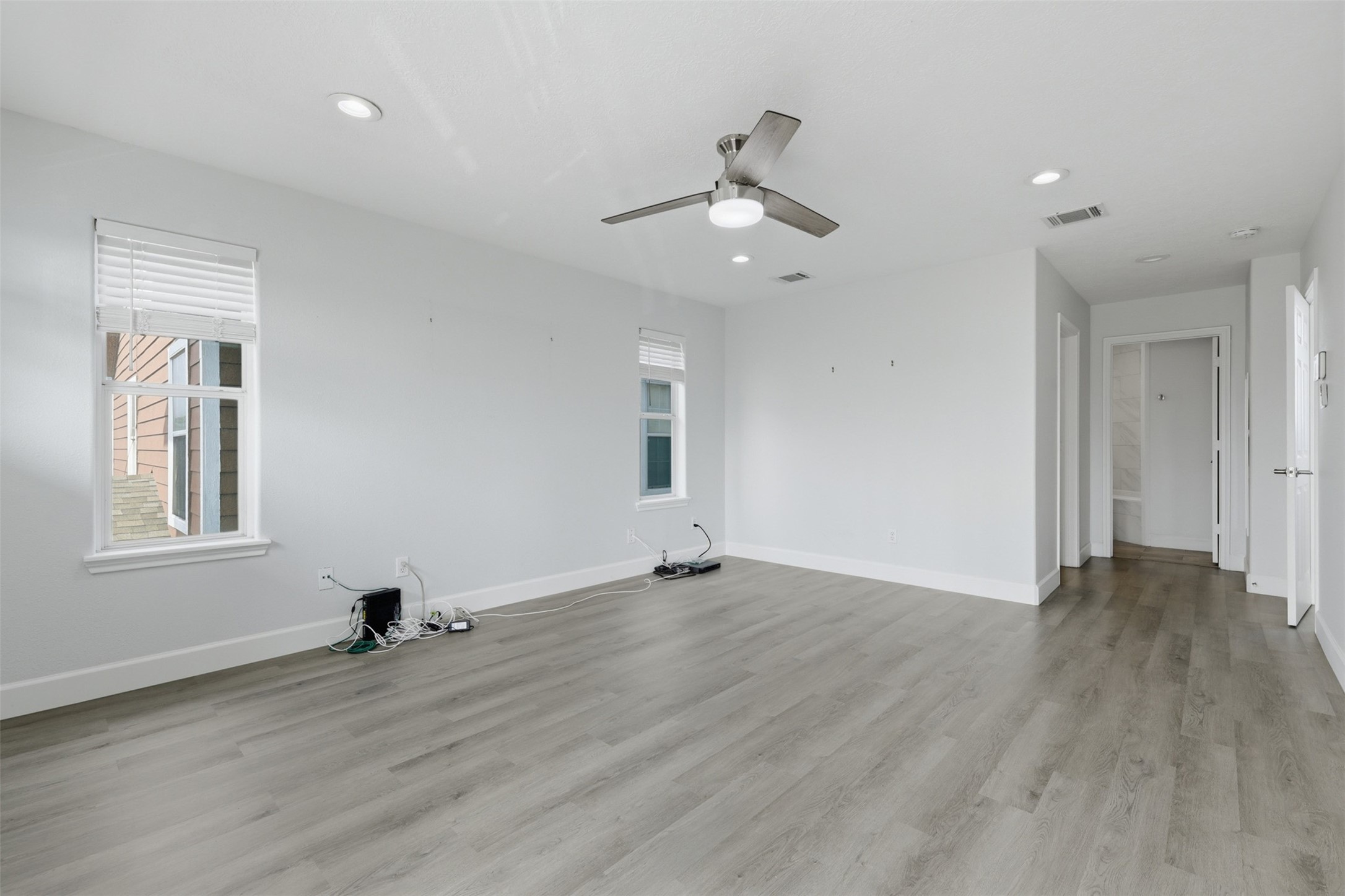9026 McGallion Road Houston, TX 77022 - Photo 17 of 35 a view of an empty room with wooden floor and a window
