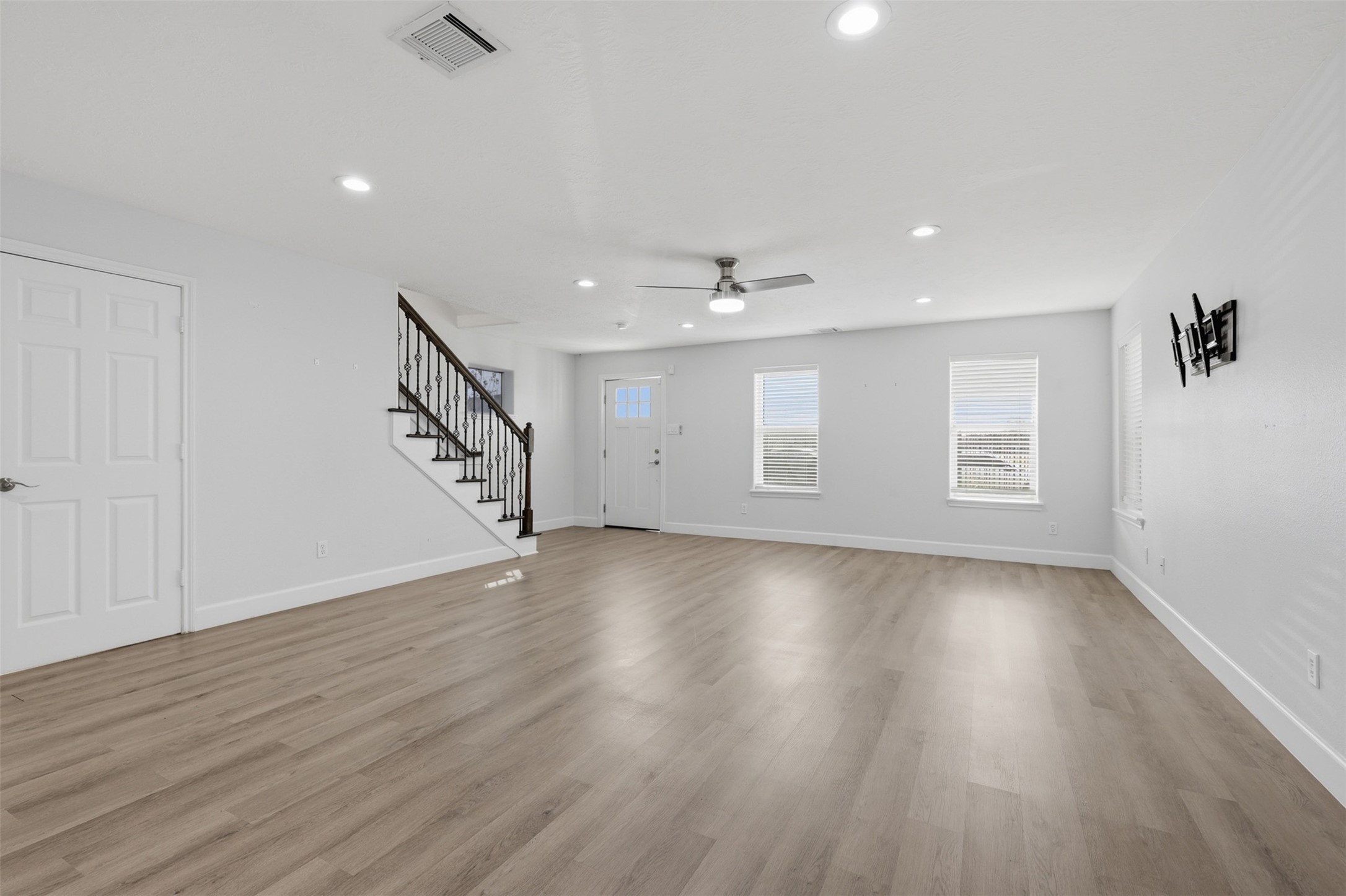 9026 McGallion Road Houston, TX 77022 - Photo 8 of 35 a view of an empty room with wooden floor and a window
