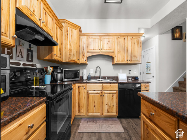 40 Ginger Gold Road Santaquin, UT 84655 - Photo 4 of 32 Kitchen featuring wood cabinetry, dark countertops, a stainless steel sink, black appliances, and wood-finish flooring