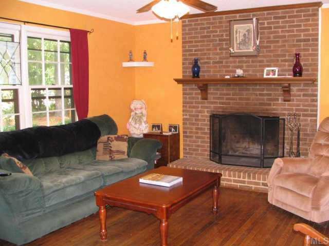 1710 Cranston Road Garner, NC 27529 - Photo 4 of 7 a living room with furniture and a fireplace