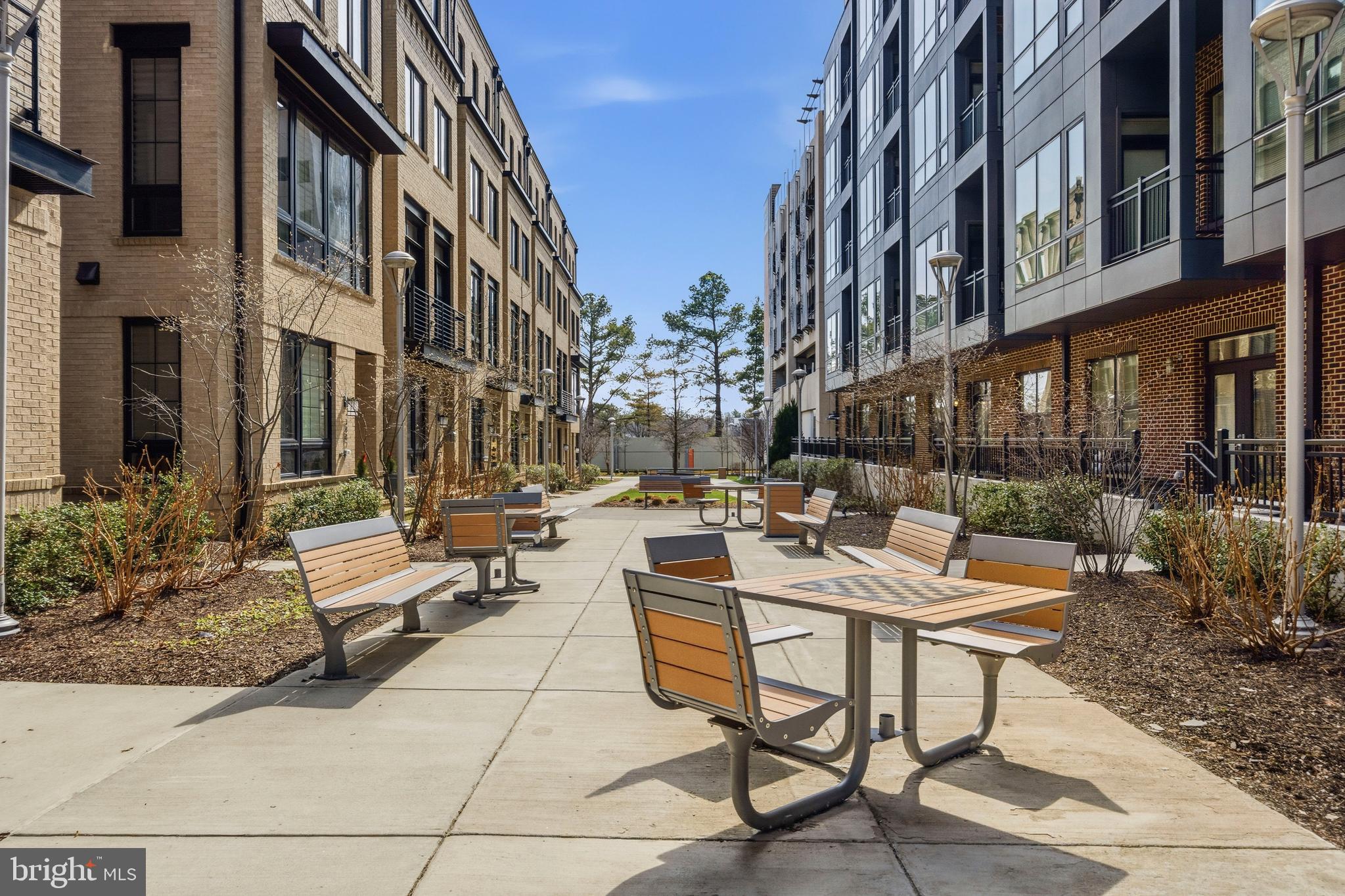 1878 Easterly Road Reston, VA 20190 - Photo 39 of 63 a view of a patio with a table and chairs and potted plants