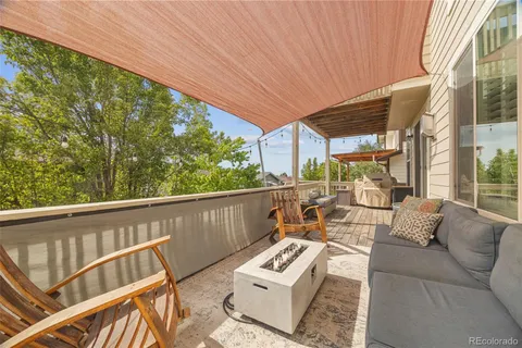 a view of outdoor living space with furniture and garden view