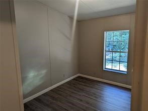 12186 Hairston Circle Willis, TX 77318 - Photo 11 of 16 an empty room with wooden floor and windows