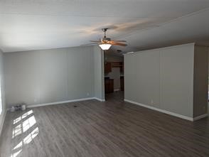 12186 Hairston Circle Willis, TX 77318 - Photo 13 of 16 a view of empty room with wooden floor and ceiling fan