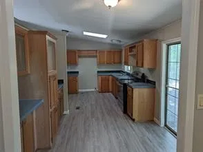 a kitchen with a refrigerator and a stove top oven