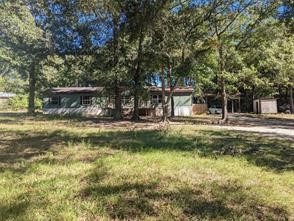 12186 Hairston Circle Willis, TX 77318 - Photo 2 of 16 a view of swimming pool with a garden