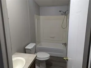 a bathroom with a toilet sink and shower