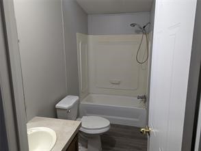 12186 Hairston Circle Willis, TX 77318 - Photo 4 of 16 a bathroom with a toilet sink and shower