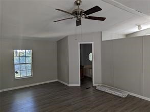 12186 Hairston Circle Willis, TX 77318 - Photo 5 of 16 an empty room with wooden floor chandelier fan and windows