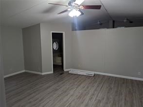 12186 Hairston Circle Willis, TX 77318 - Photo 6 of 16 an empty room with wooden floor closet and windows