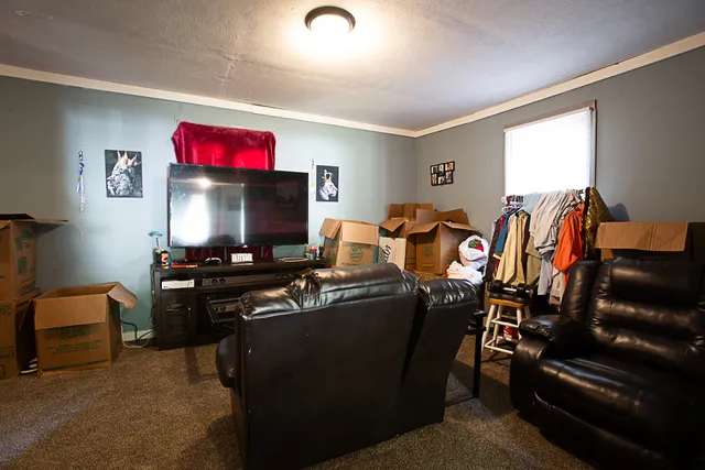 a living room with furniture and a flat screen tv