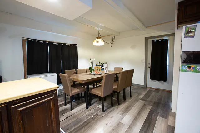 a view of a dining room with a table and chairs