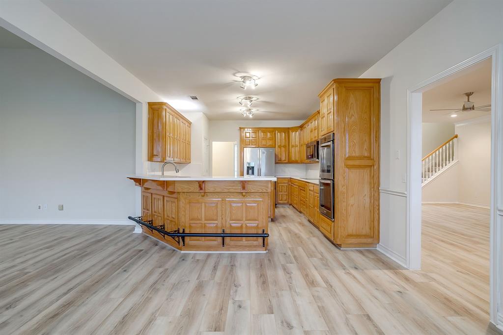 125 View Point Court Aledo, TX 76008 - Photo 18 of 34 a view of kitchen with cabinets and wooden floor