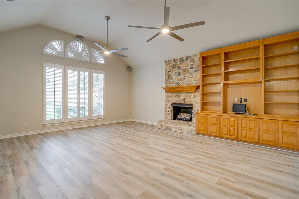 125 View Point Court Aledo, TX 76008 - Photo 19 of 34 an empty room with wooden floor fireplace and windows