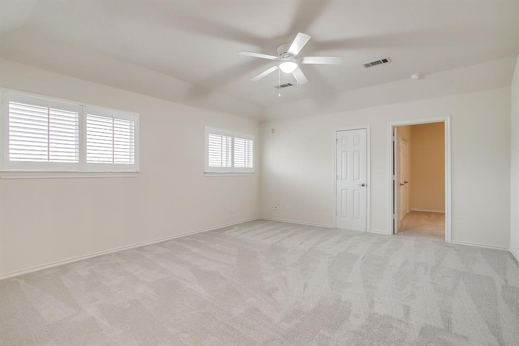 125 View Point Court Aledo, TX 76008 - Photo 24 of 34 an empty room with chandelier fan and windows
