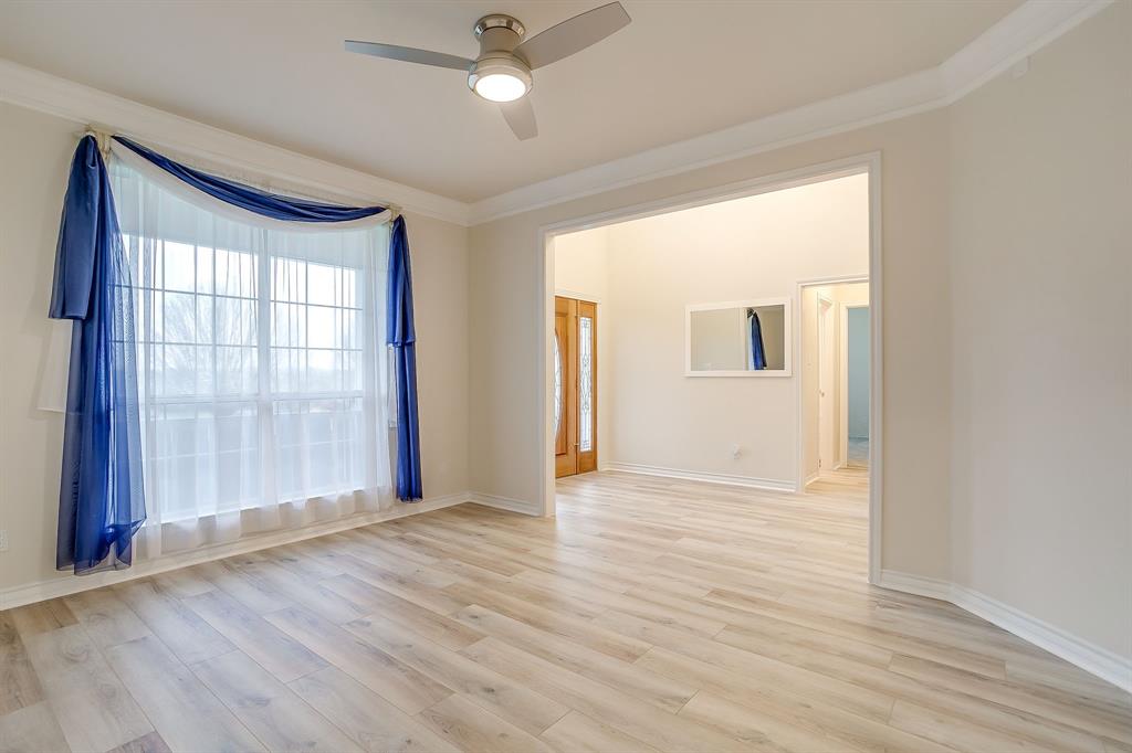 125 View Point Court Aledo, TX 76008 - Photo 8 of 34 an empty room with wooden floor and windows