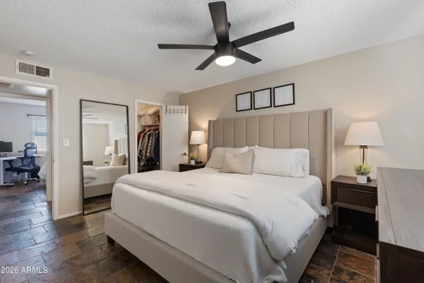 a bedroom with a bed and a chandelier