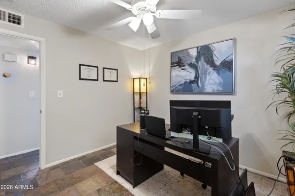 a view of a workspace with furniture and a fireplace