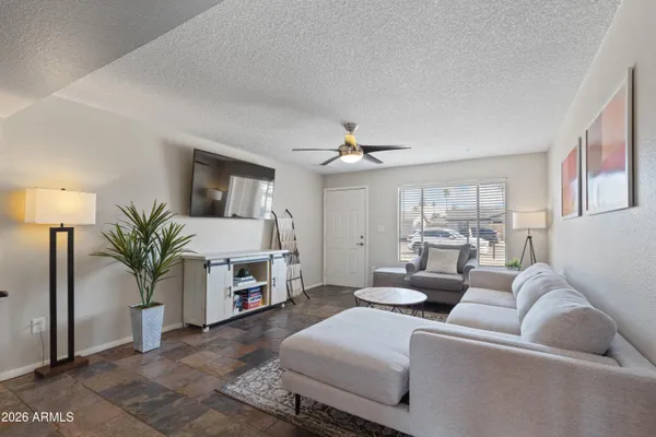 a living room with furniture and a fireplace