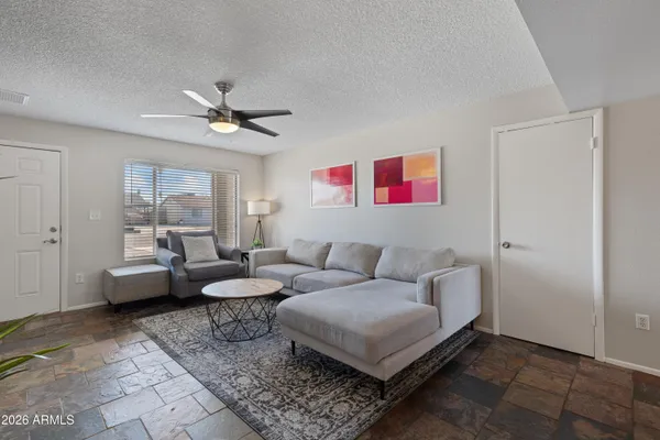 a living room with furniture and a large window