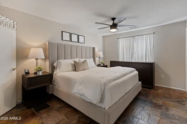 a bedroom with a bed and a lamp