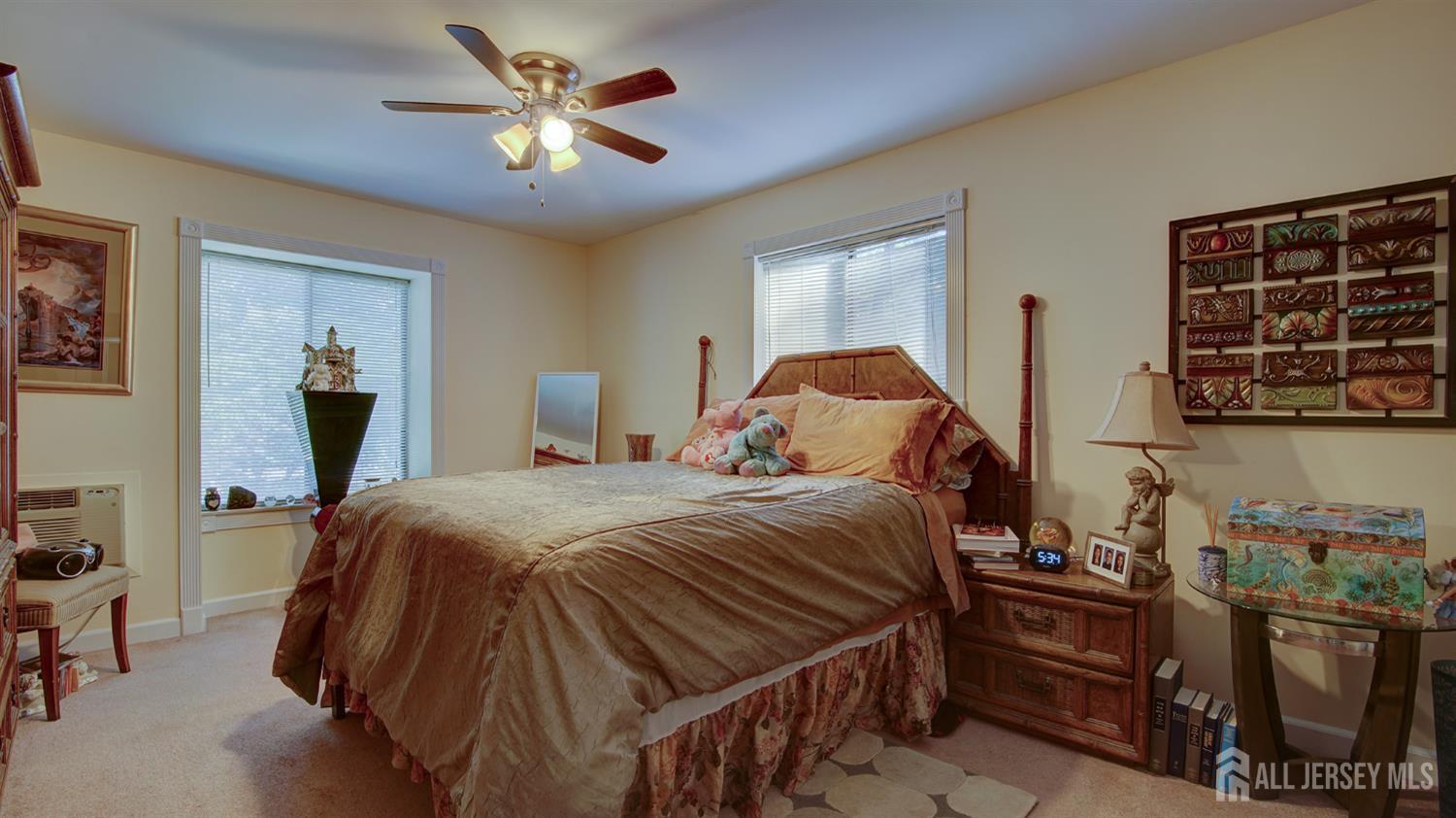 86 Arrowood Road, Unit G Manalapan, NJ 07726 - Photo 9 of 16 a bedroom with bed and flowerpot