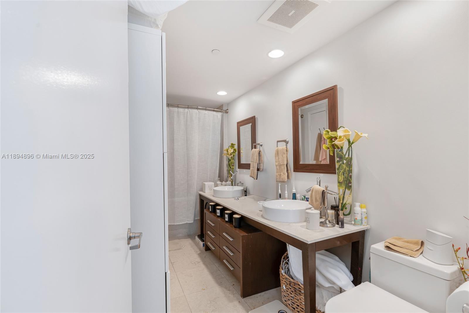 475 Brickell Avenue, Unit 3111 Miami, FL 33131 - Photo 12 of 24 a bathroom with a toilet sink and mirror