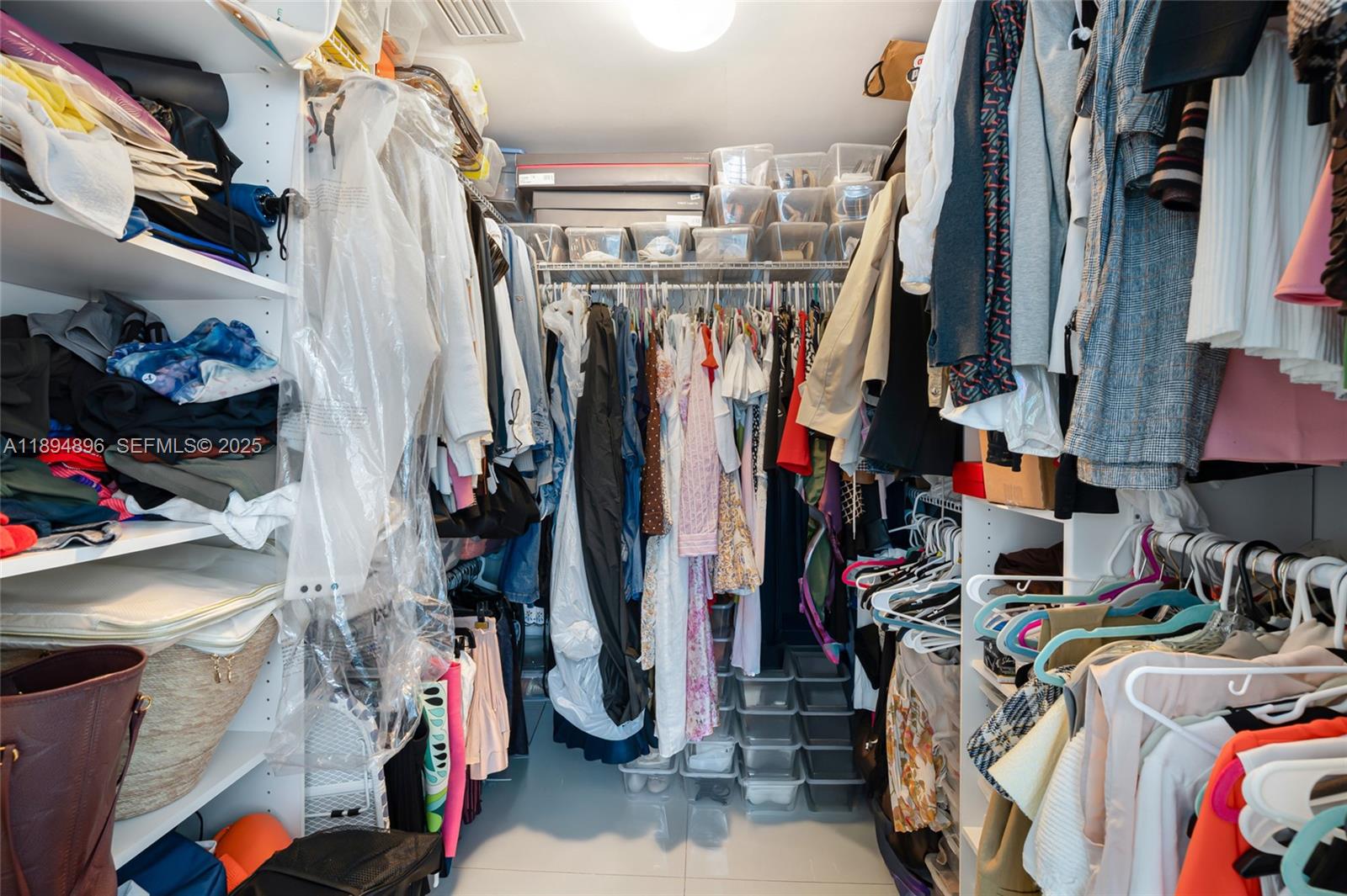 475 Brickell Avenue, Unit 3111 Miami, FL 33131 - Photo 14 of 24 a view of walk in closet with clothes and shoes