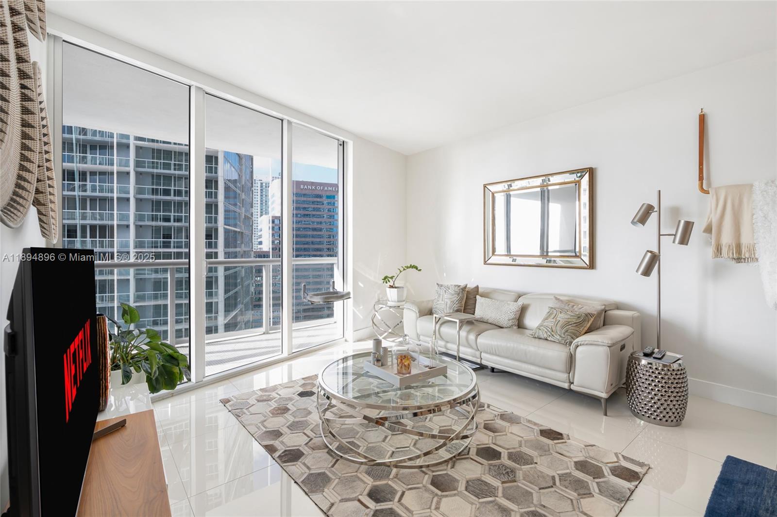 475 Brickell Avenue, Unit 3111 Miami, FL 33131 - Photo 4 of 24 a living room with furniture and a potted plant