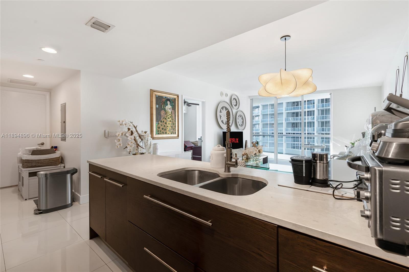 475 Brickell Avenue, Unit 3111 Miami, FL 33131 - Photo 8 of 24 a kitchen with stainless steel appliances a sink a stove and a wooden floors