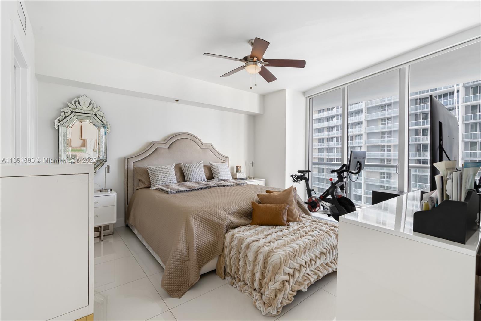 475 Brickell Avenue, Unit 3111 Miami, FL 33131 - Photo 9 of 24 a bedroom with bed a couch and a flat tv screen