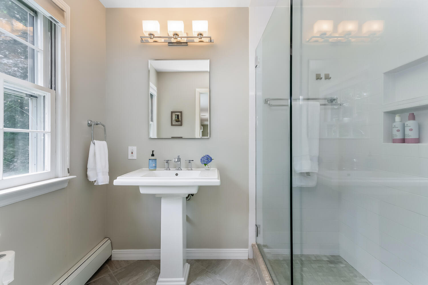 21 Middlesex Road Darien, CT 06820 - Photo 23 of 40 a bathroom with a sink a mirror and shower