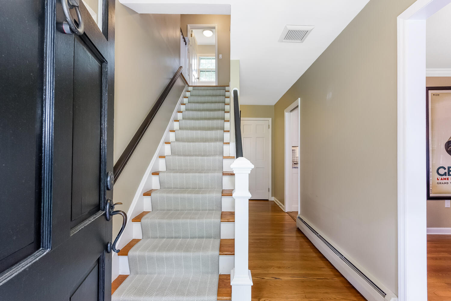 21 Middlesex Road Darien, CT 06820 - Photo 4 of 40 a view of staircase with lots of frames on wall and wooden floor