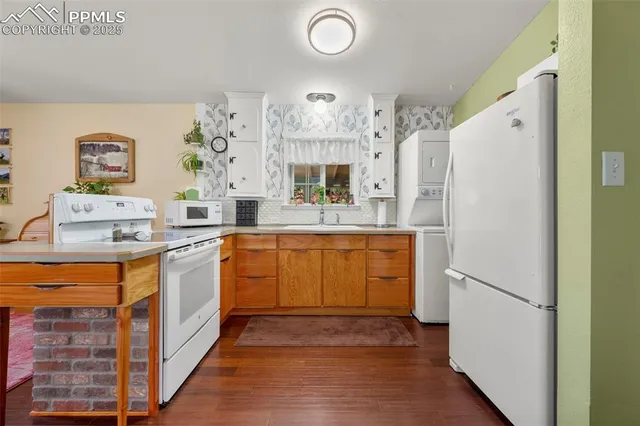 a kitchen with a sink and a refrigerator