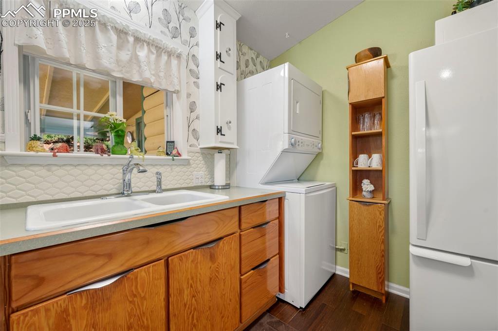 183 Beaver Pond Road Divide, CO 80814 - Photo 13 of 28 a kitchen with a sink and a refrigerator