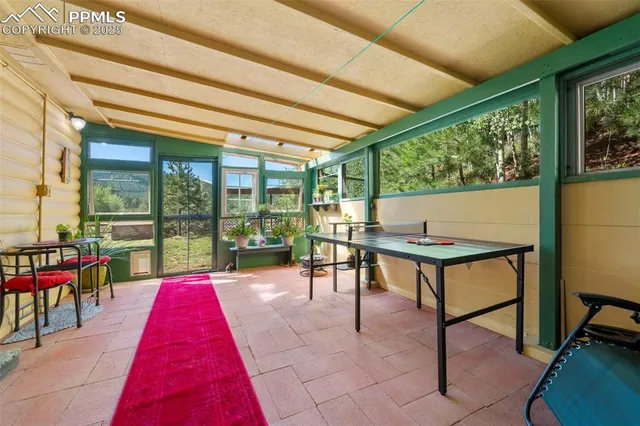 a backyard of a house with table and chairs