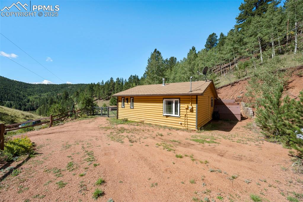 183 Beaver Pond Road Divide, CO 80814 - Photo 25 of 28 a backyard of a house with large trees