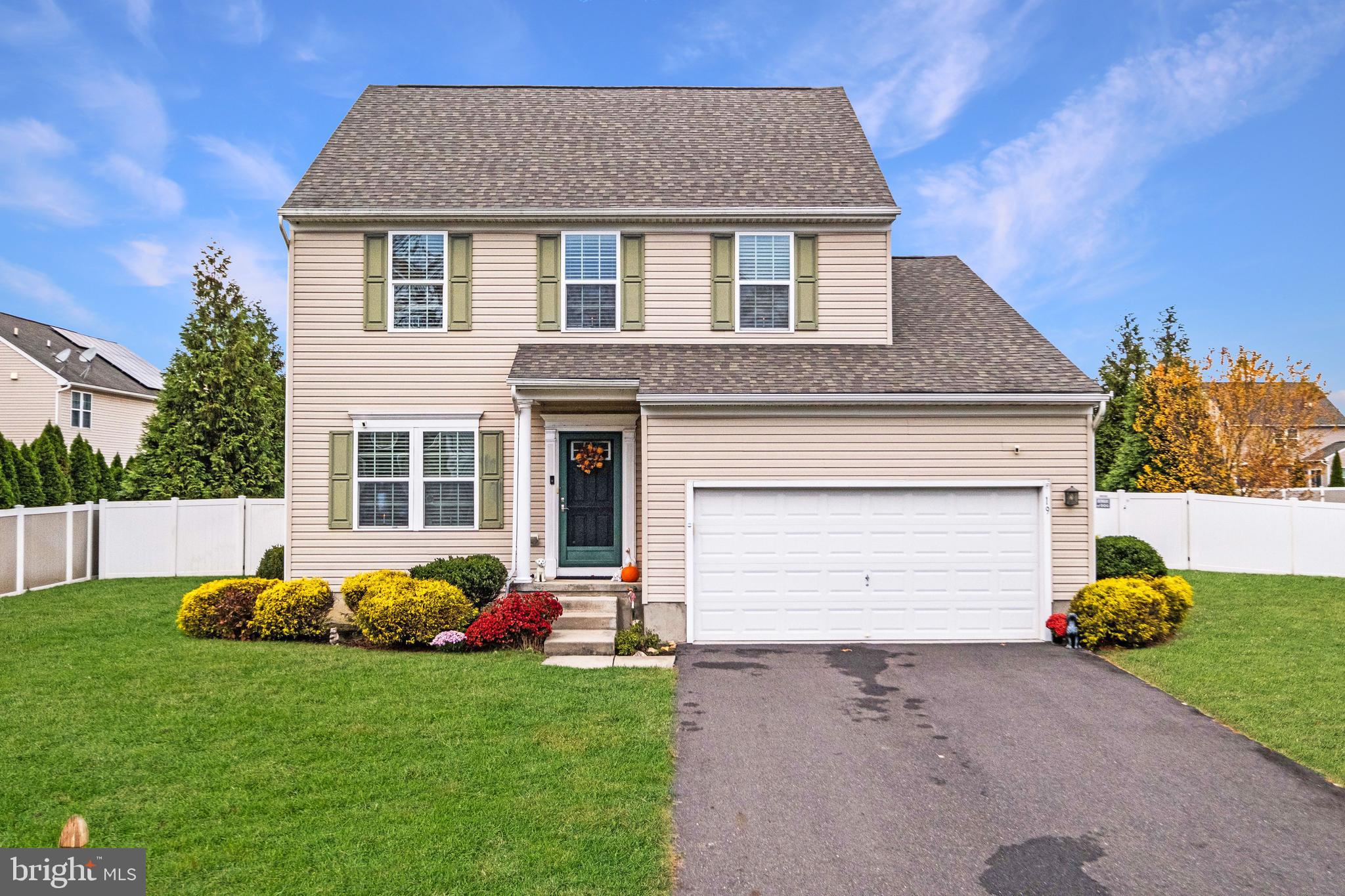 a front view of a house with a garden and plants