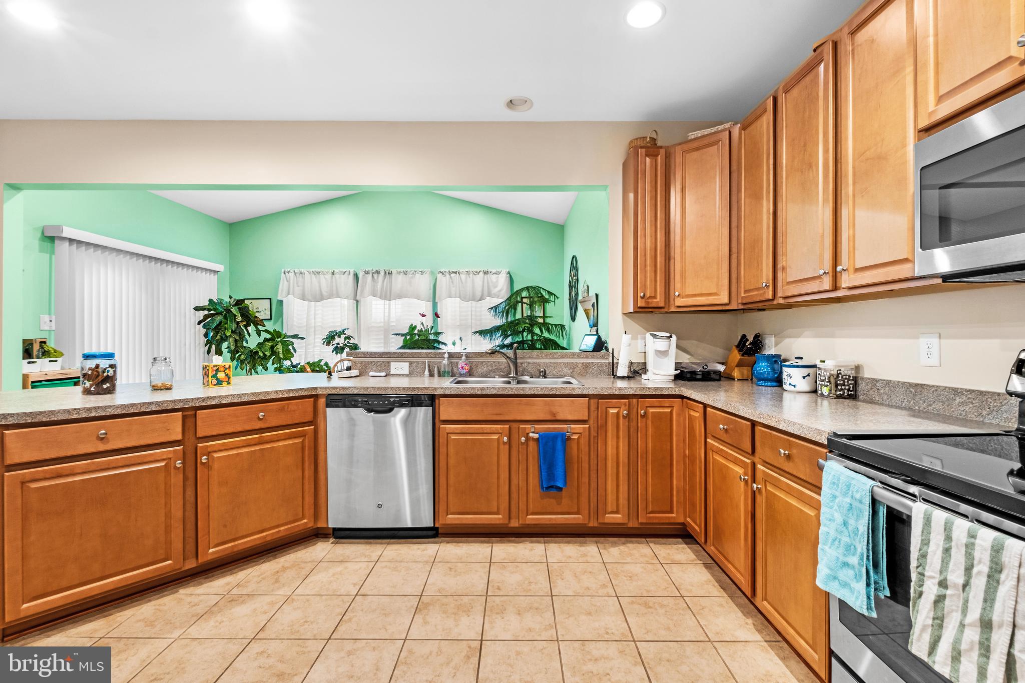 19 Vaughn Way Burlington, NJ 08016 - Photo 15 of 43 a large kitchen with stainless steel appliances granite countertop a stove a sink and a microwave