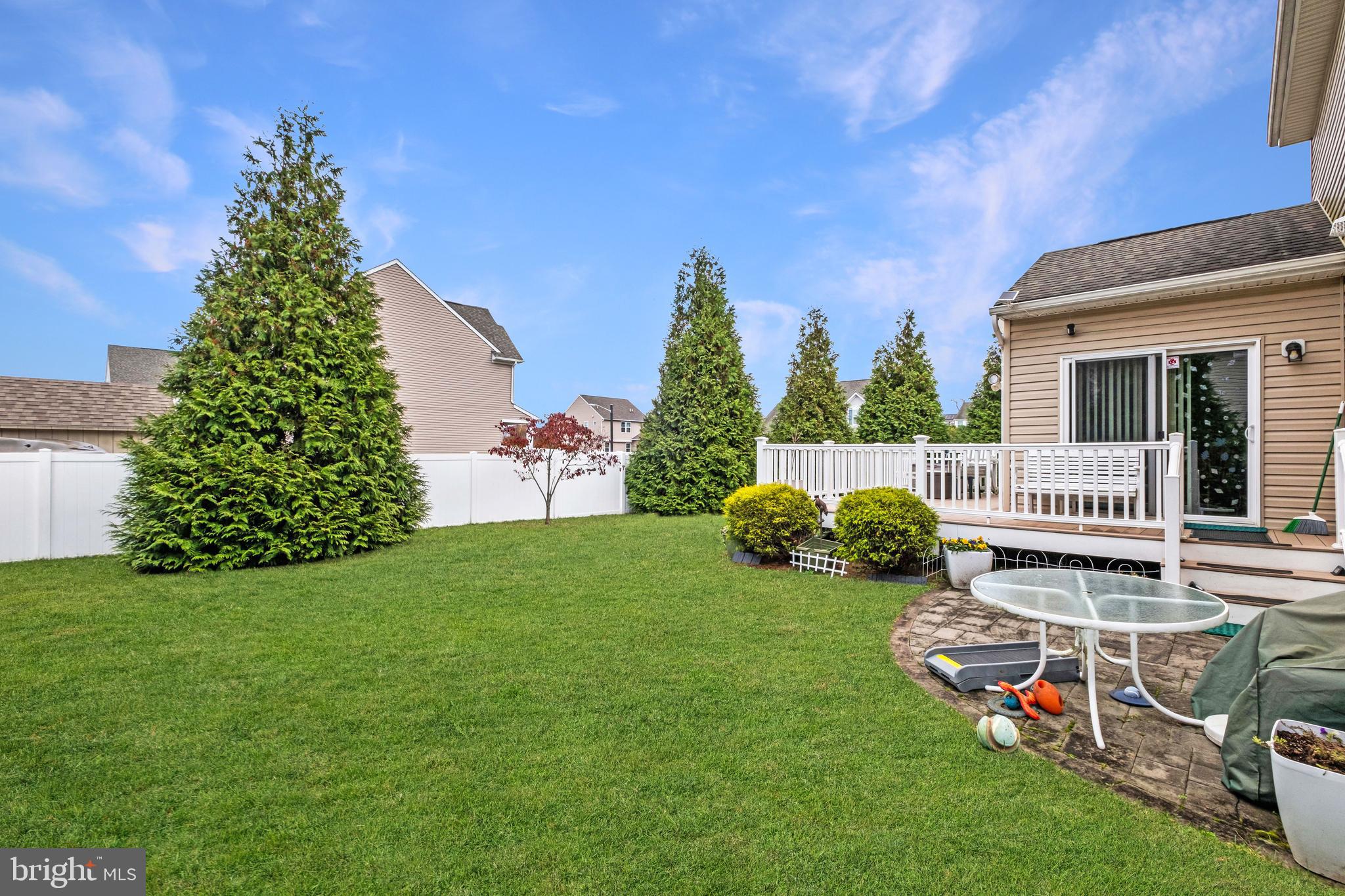 19 Vaughn Way Burlington, NJ 08016 - Photo 39 of 43 a view of a chair and table on the green field