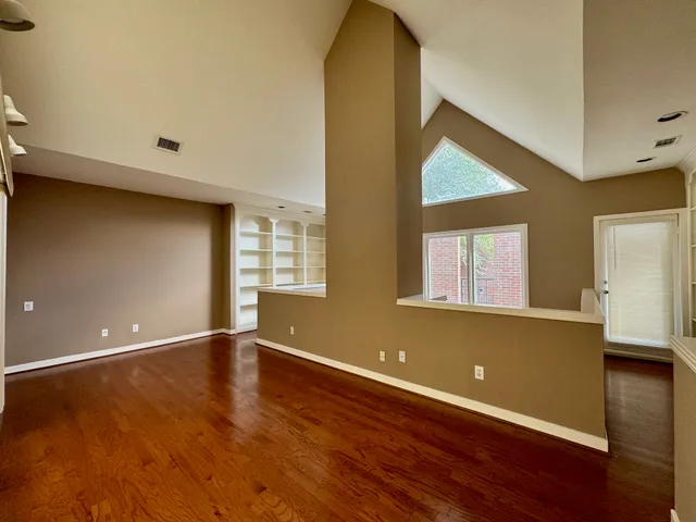 a view of room with window and wooden floor