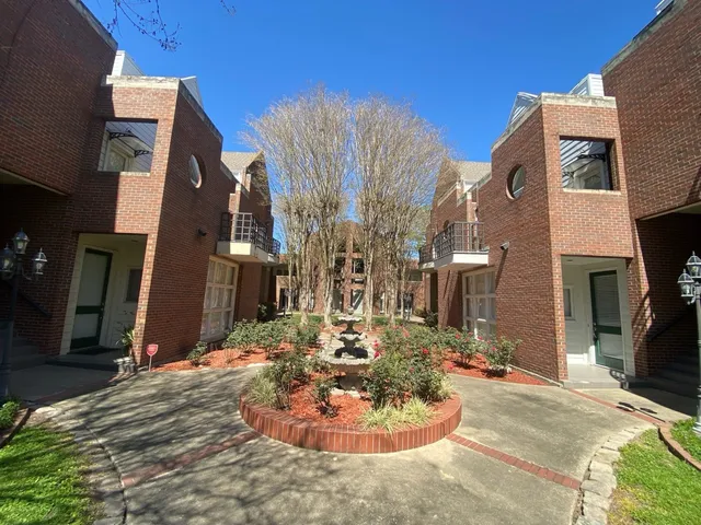 a large building with swimming pool in front of it