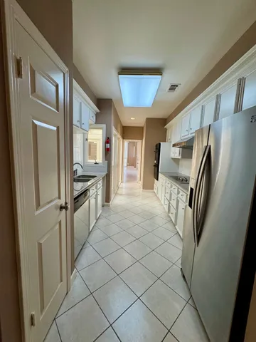 a kitchen with stainless steel appliances a refrigerator and a sink